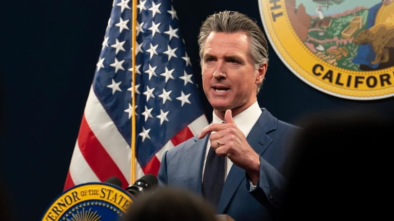 California Gov. Gavin Newsom answers a reporters question about his...