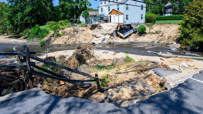 The damaged and flooded Harbor Road in Head of the...