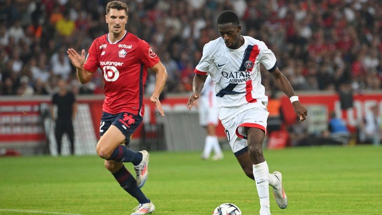 PSG's Ousmane Dembele runs with the ball watched by Lille's...