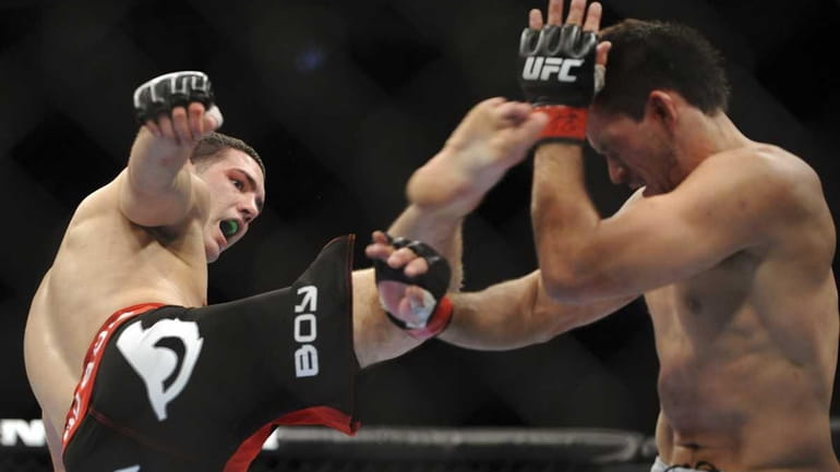 Chris Weidman kicks Demian Maia in a Middleweight out during...