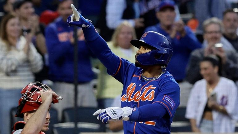 Francisco Lindor #12 of the Mets celebrates his fourth inning home...