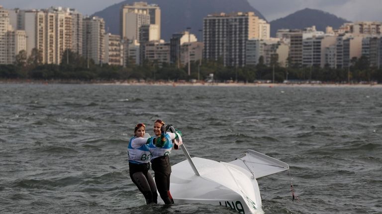 Brazil's Kahena Kunze, left, and Martine Grael celebrate after winning...