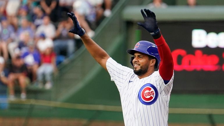 FILE_ Chicago Cubs' Jeimer Candelario celebrates his single off Cincinnati...