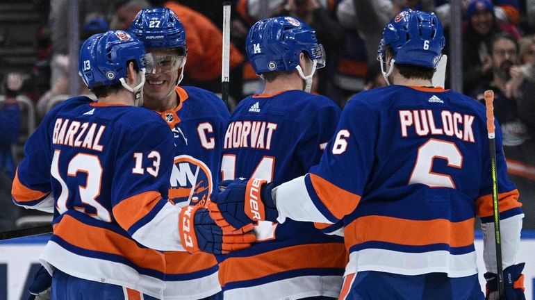 Islanders players celebrate a goal by center Bo Horvat in...