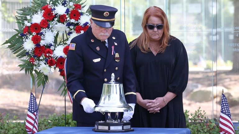 Suffolk County Fire District Officers Association president Robert McConville, left,...