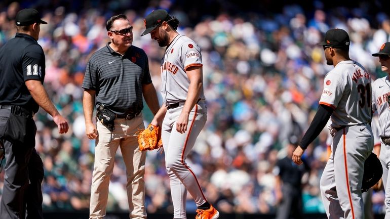 San Francisco Giants starting pitcher Robbie Ray, third from left,...