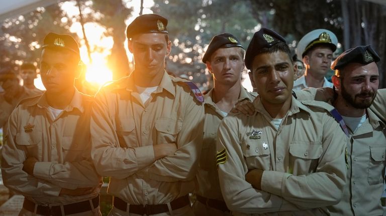 Israeli Navy sailors mourn during the funeral of Petty Officer...