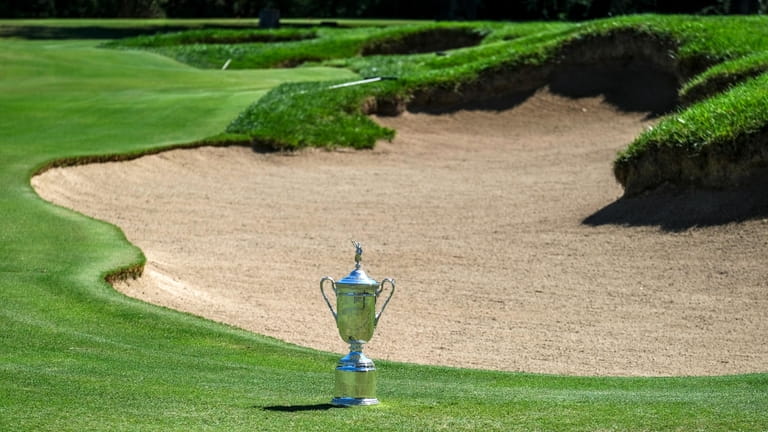The championship trophy is displayed next to a bunker at...