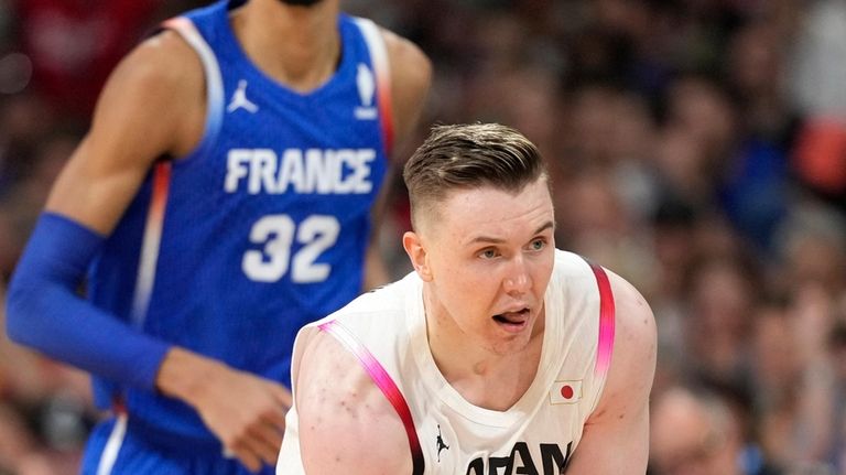 Japan's Josh Hawkinson, right, celebrates after scorn as France's Victor...