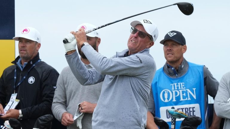 Phil Mickelson of the United States watches his tee shot...