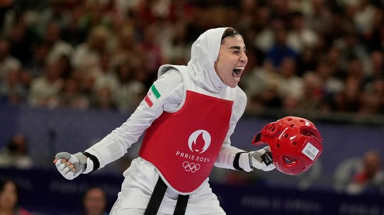 Iran's Nahid Kiyanichandeh reacts at the end of a women's...