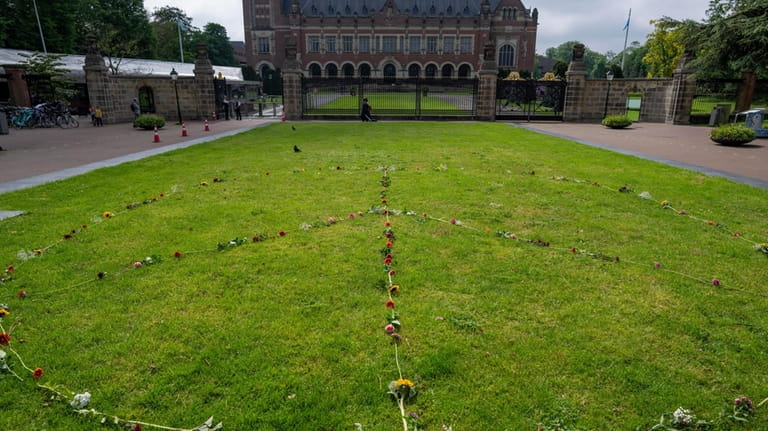 A Peace Sign is laid out with flowers outside the...