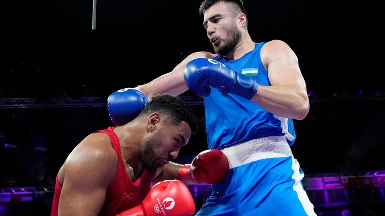 Uzbekistan's Bakhodir Jalolov hits Norway's Omar Shiha in their men's...