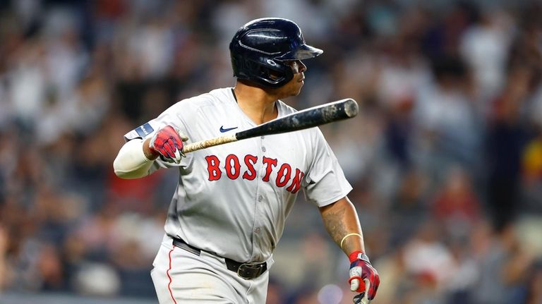 Boston Red Sox's Rafael Devers tosses his bat after hitting...