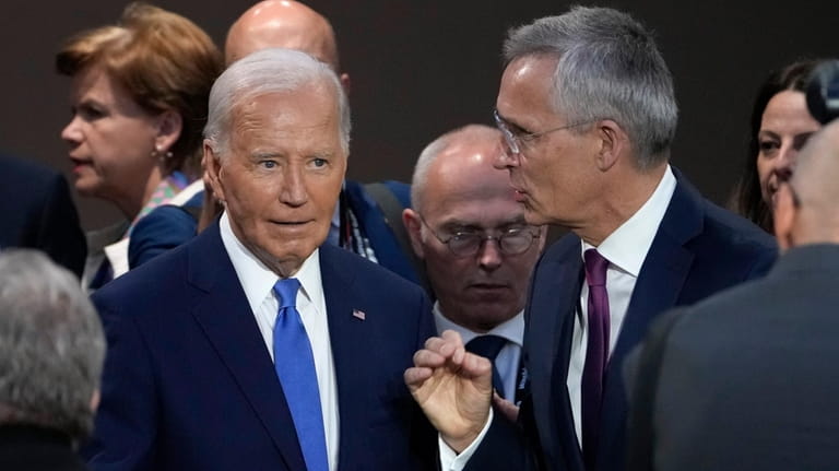 President Joe Biden, left, speaks with Secretary General of NATO...