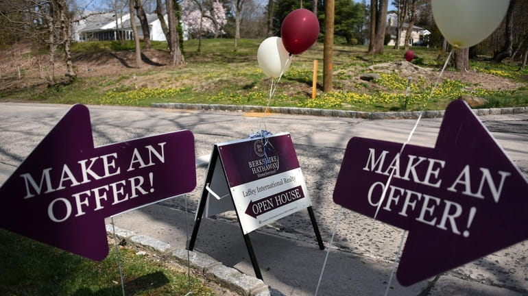 A sign advertises an open house in Roslyn Harbor in April last...