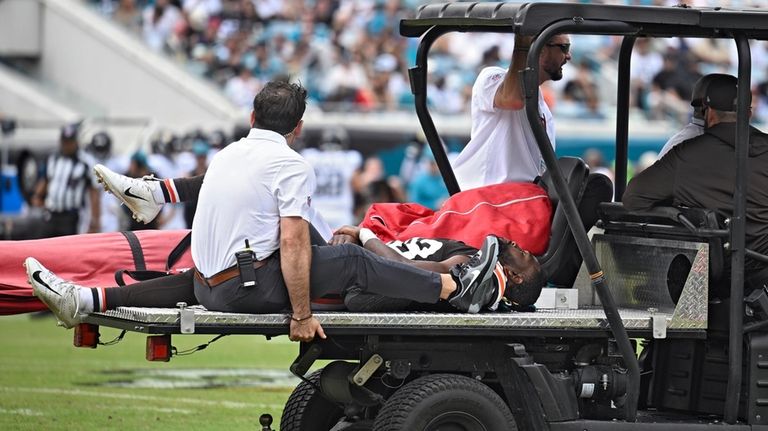 Cleveland Browns wide receiver David Bell (18) is taken off...