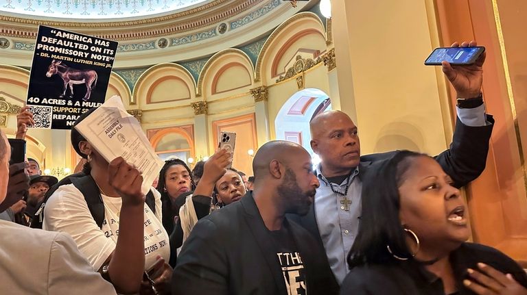 Members of Coalition for a Just and Equitable California protest...