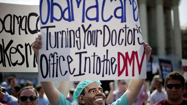 An opponent of President Barack Obama's health care law demonstrates...