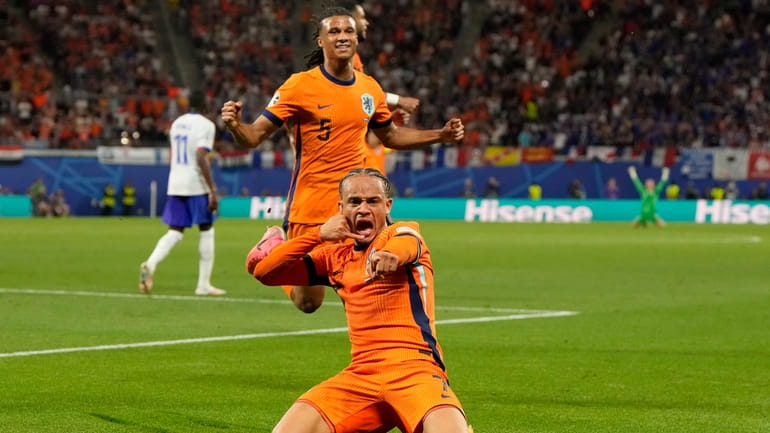 Xavi Simons of the Netherlands, center, celebrates after scoring a...
