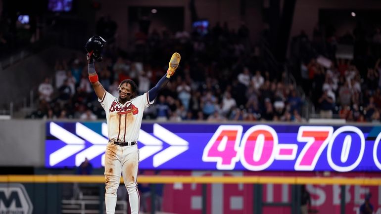 Atlanta Braves' Ronald Acuña Jr. (13) thanks the crowd for...