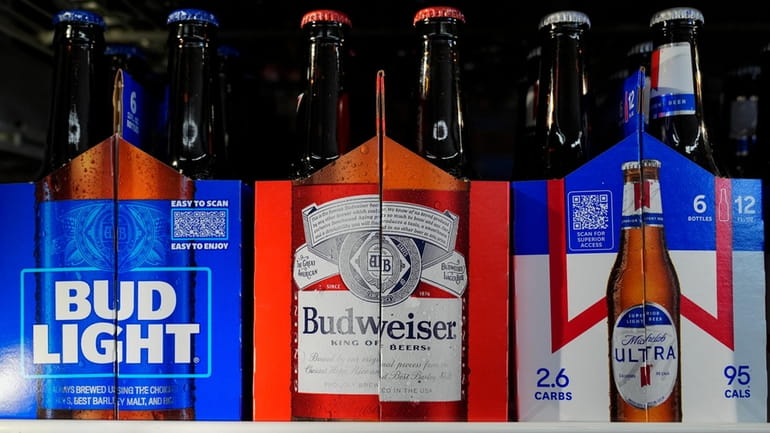 Six-packs of Bud Light, Budweiser and Michelob Ultra are displayed...