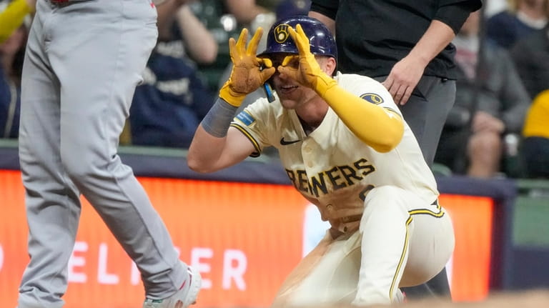 Milwaukee Brewers' Jake Bauers reacts after hitting a two-run scoring...