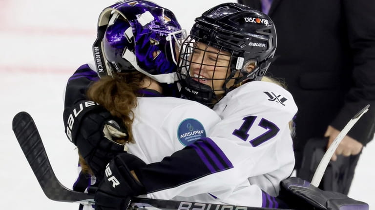 Minnesota forward Brooke Bryant (17) hugs goalie Nicole Hensley after...