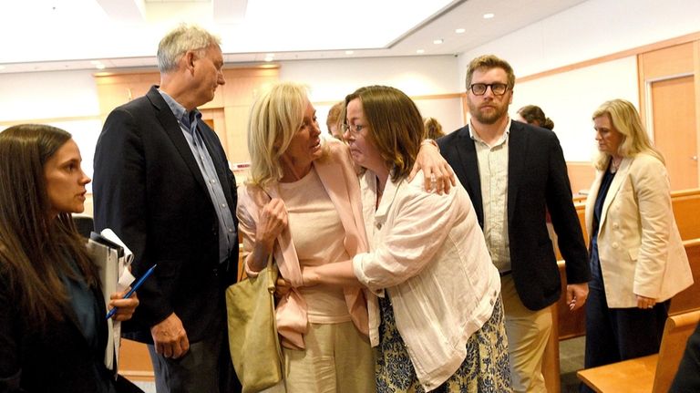 Alexandra Eckersley, right, leaves the courtroom sobbing with her mother,...