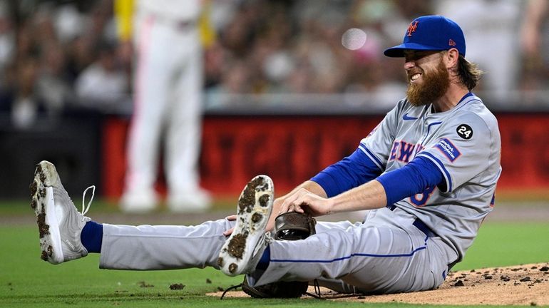 Paul Blackburn of the Mets reacts after being hit by...