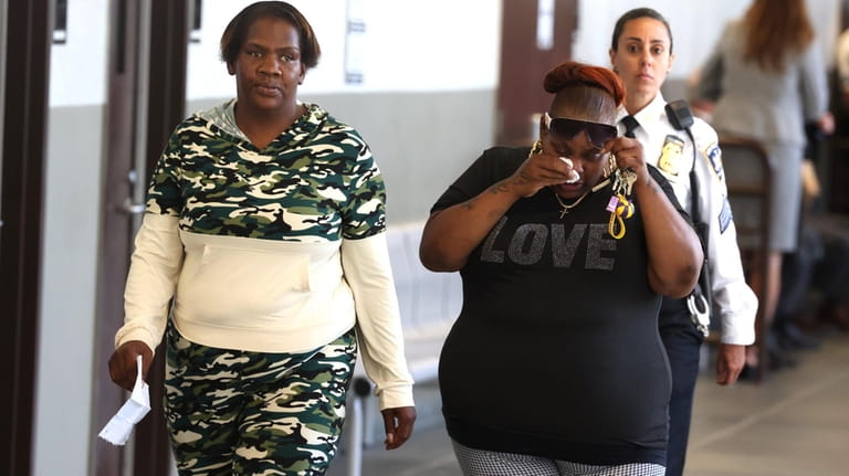 Tiyuana Jackson, right, Janell Funderburke's mother, walks with a friend after...