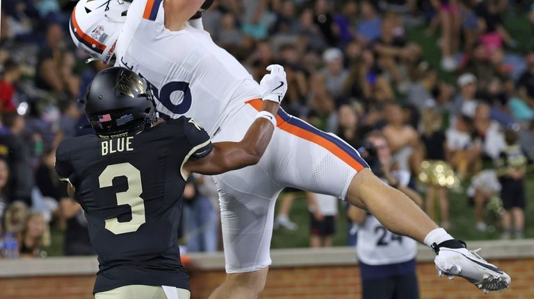 Virginia tight end Tyler Neville, top, pulls down a touchdown...