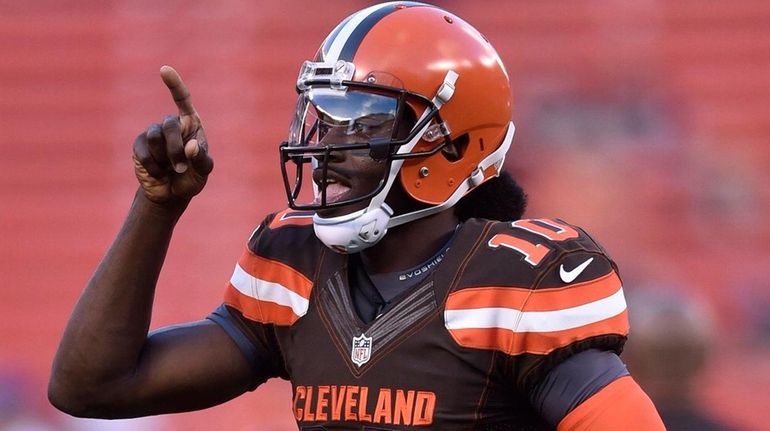 Cleveland Browns quarterback Robert Griffin III runs onto the field...