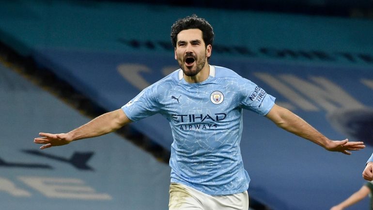 Manchester City's Ilkay Gundogan celebrates after scoring his side's third...