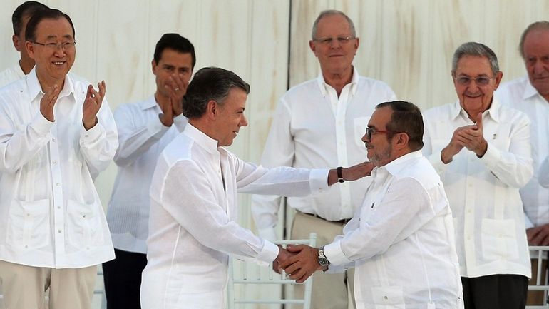 Colombia's President Juan Manuel Santos, front left, and the top...