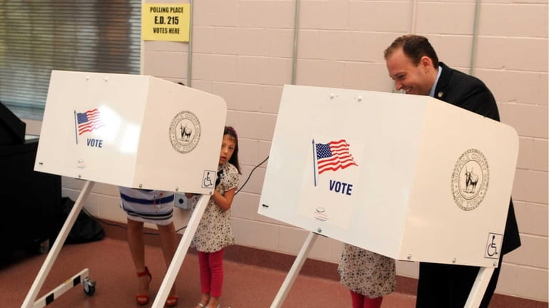 State Sen. Lee Zeldin casts his vote at the Mastic...