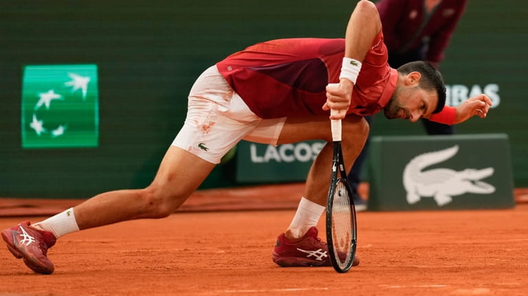 Serbia's Novak Djokovic slipped during his fourth round match of...