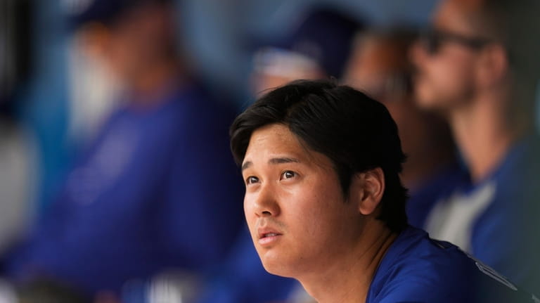 Los Angeles Dodgers designated hitter Shohei Ohtani sits in the...