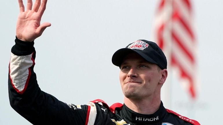 Josef Newgarden waves after winning the IndyCar Series auto race...