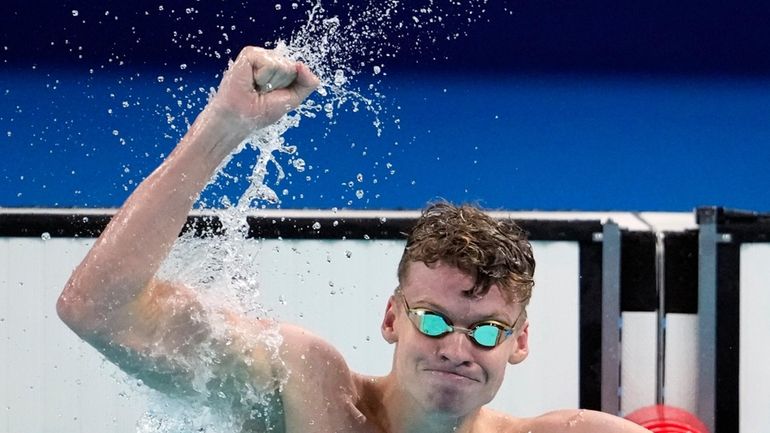 Leon Marchand, of France, celebrates after winning the men's 200-meter...