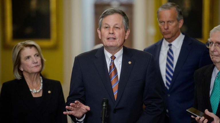 Sen. Steve Daines, R-Mont., center, is joined from left by...