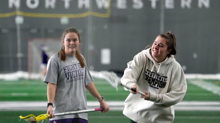Northwestern's Erin Coykendall, left, watches Izzy Scane shoot as they...