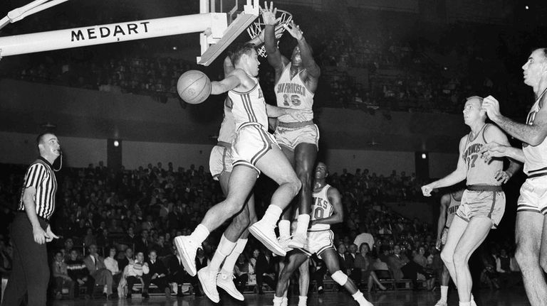 St. Louis Hawks Cliff Hagan (16) looks to pass as...