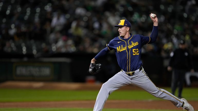 Milwaukee Brewers pitcher Bryan Hudson throws to an Oakland Athletics...