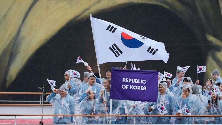 The boat carrying team South Korea makes its way down...