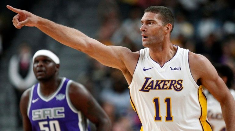 Lakers center Brook Lopez points to the fans after a...