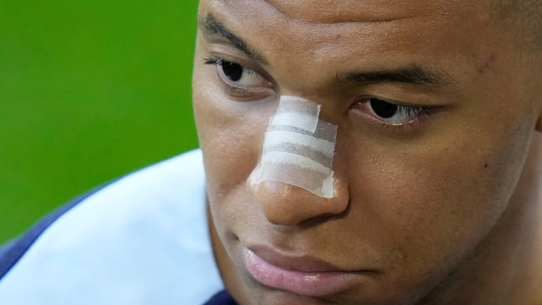 France's Kylian Mbappe gestures as he leaves the field after...
