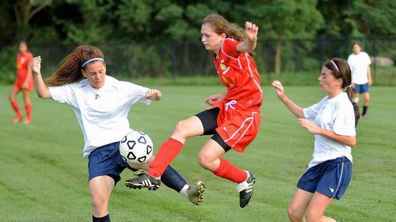 Sacred Heart's #7 Grace Agolia (wearing red) flies through the...