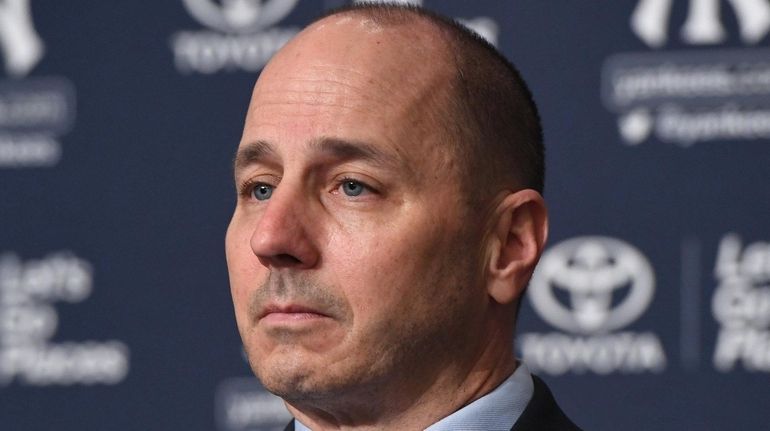 Yankees general manager Brian Cashman looks on during a press...