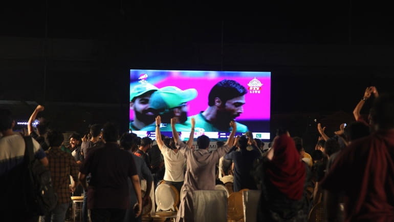 Pakistani cricket fans watch the ICC Men's T20 World Cup...